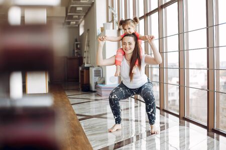Mother and daughter training in a gymの写真素材
