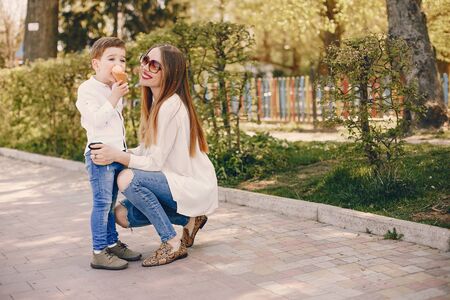 Mother with son playing in a summer parkの写真素材