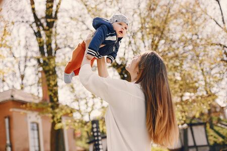 Mother with son playing in a summer parkの写真素材