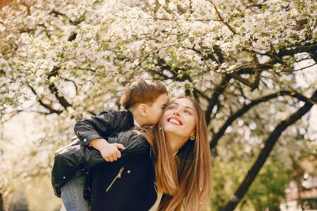 Mother with son playing in a summer parkの写真素材