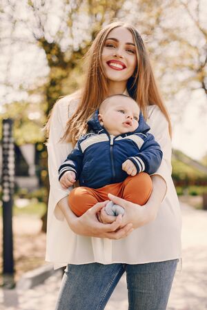 Mother with son playing in a summer parkの写真素材
