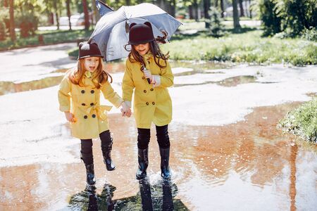 Cute kids plaiyng on a rainy dayの写真素材
