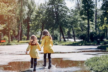 Cute kids plaiyng on a rainy dayの写真素材
