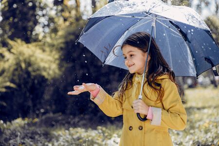 Cute kid plaiyng on a rainy dayの写真素材
