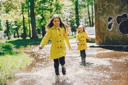 Cute kids plaiyng on a rainy dayの写真素材