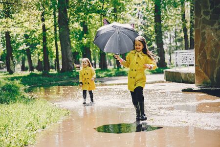 Cute kids plaiyng on a rainy dayの写真素材