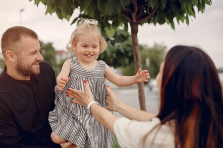 Family with daughter playing in a parkの写真素材