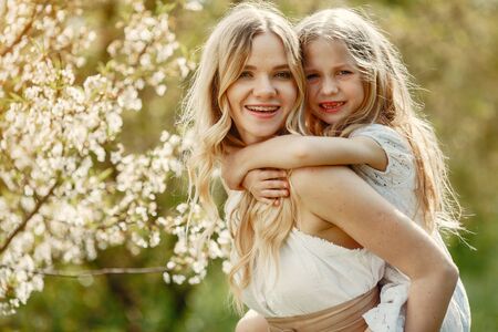 Cute and stylish family in a spring parkの写真素材