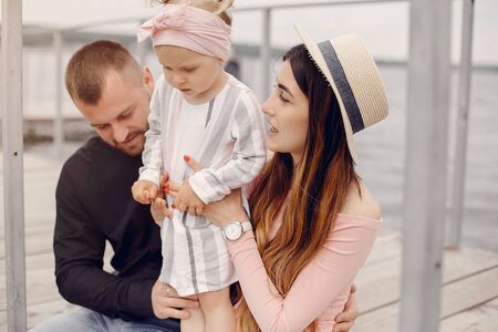 Family with daughter playing in a parkの写真素材