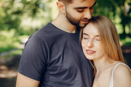 Beautiful couple spend time on a summer forestの写真素材