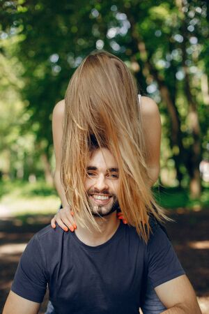 Beautiful couple spend time on a summer forestの写真素材
