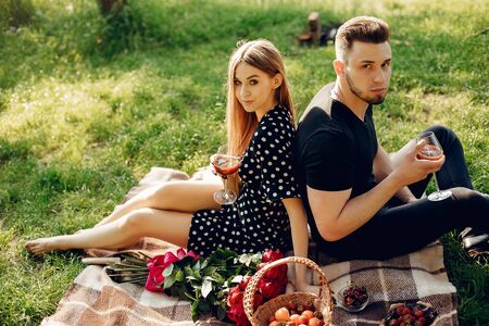 Beautiful couple spend time in a summer fieldの写真素材