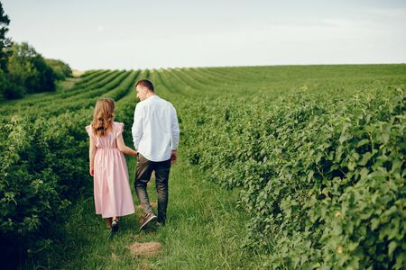 Beautiful couple spend time on a summer fieldの写真素材