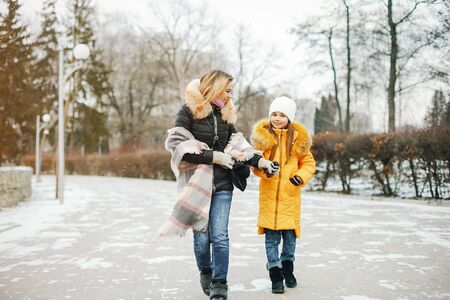 Mother with daughter in a parkの写真素材