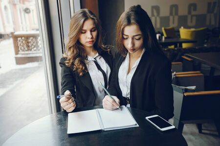 two businesswomen in a cafeの写真素材