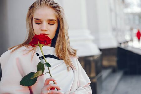 pretty blonde with roseの写真素材