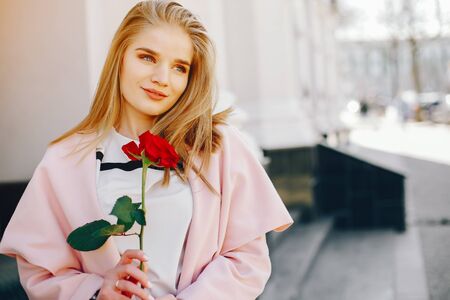 pretty blonde with roseの写真素材