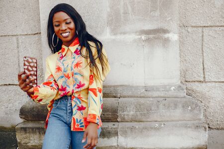 stylish black girl in a cityの写真素材