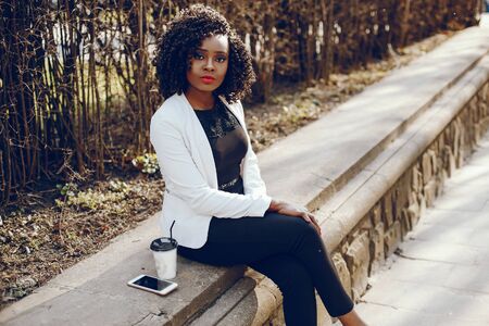 stylish black girl in a cityの写真素材