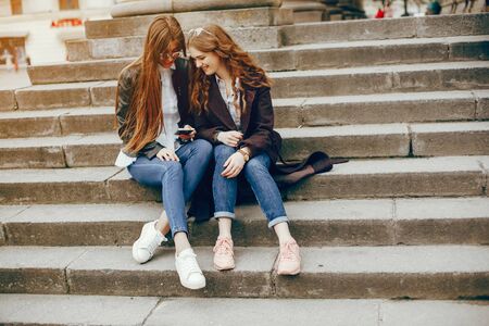 two stylish girl in a cityの写真素材
