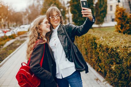 two stylish girl in a cityの写真素材