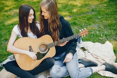 Two girls with a guitarの写真素材
