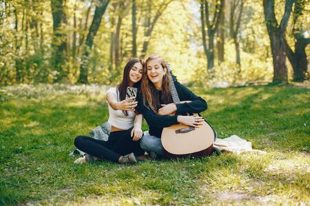 Two girls with a guitarの写真素材