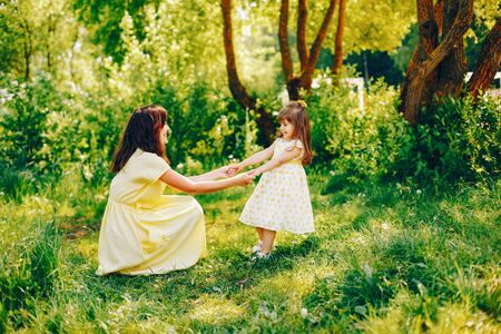 mother with daughter in a solar parkの写真素材