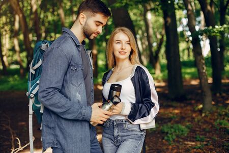 Cute couple have a rest in a summer forest