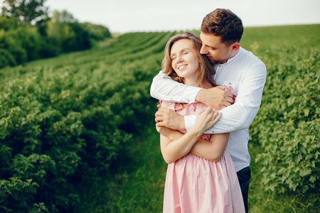 Beautiful couple spend time on a summer fieldの写真素材