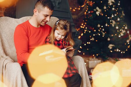 Handsome father sitting at home with little childの写真素材