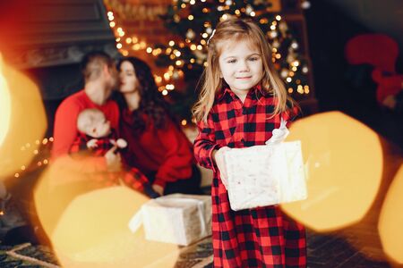 Family sitting at home near christmas treeの写真素材