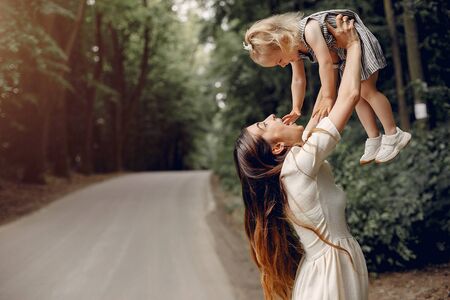 Mother with daughter. Family in a park. Cute little girlの写真素材