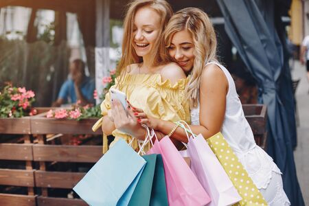 Cute girls with shopping bag in a city