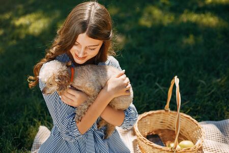 Elegant and stylish girl in a spring parkの写真素材