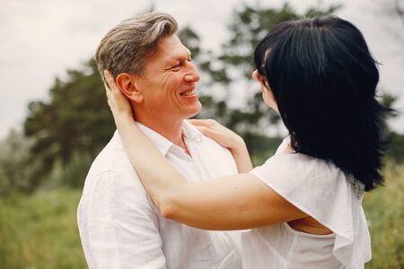 Beautiful adult couple spend time in a summer fieldの写真素材