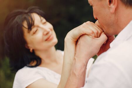Beautiful adult couple spend time in a summer field