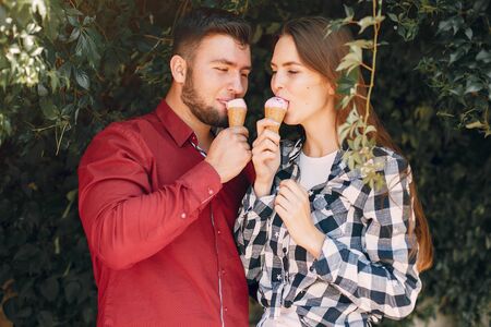 Beautiful couple spend time in a summer parkの写真素材