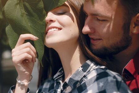 Beautiful couple spend time in a summer parkの写真素材