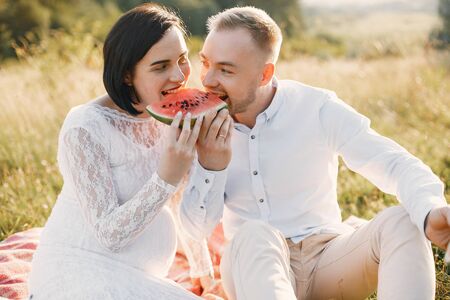 Cute family spending time in a summer fieldの写真素材
