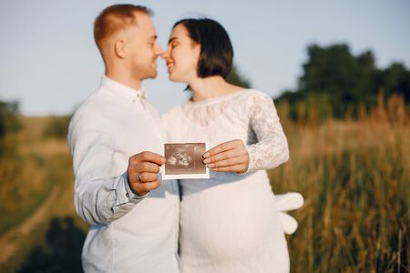 Cute family spending time in a summer fieldの写真素材