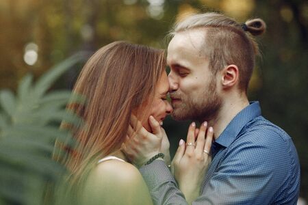Beautiful couple spend time in a summer park