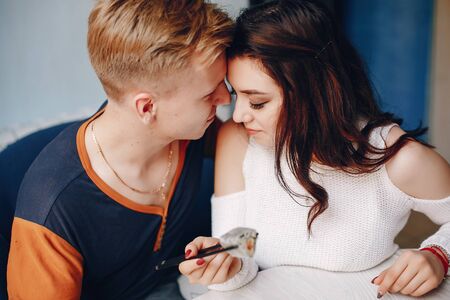 Couple sitting in a caffe and eating sushi