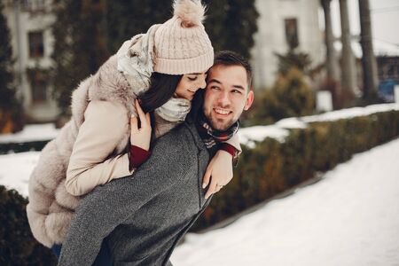 Cute and loving couple in a winter cityの写真素材
