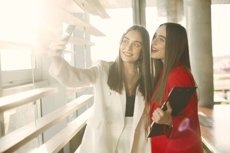 Two businesswomen working in a cafeの写真素材