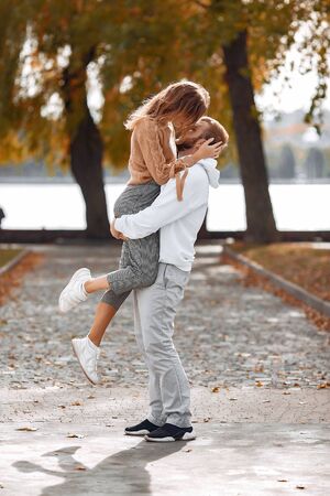 Beautiful couple spend time in a autumn parkの写真素材
