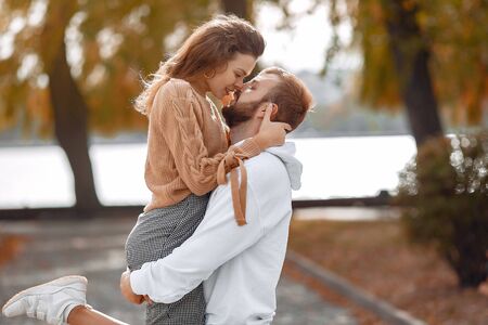 Beautiful couple spend time in a autumn parkの写真素材