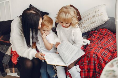 Family sitting on a bedの写真素材