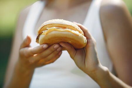 Cute and stylish girl with a humburgerの写真素材