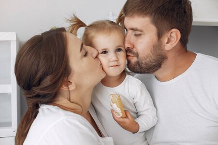 Family with little daughter having fun at home